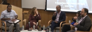 Still photo from the recording. The panel is sitting, left to right is Justin Hansford, Katie Redford, Vince Warren, Alejandra Ancheita and Baher Azmy. Vince is holding the microphone.