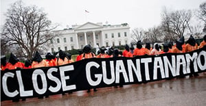 GITMO protesters holding Close Guantanamo sign in front of The White House