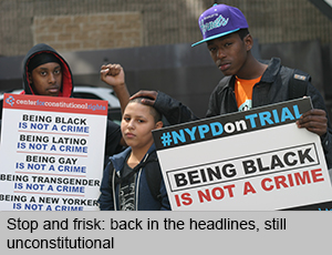 Three young people hold up signs that read 'Being Black is not a crime' 