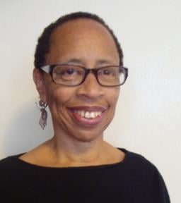 Headshot of Linda Burnham in black shirt in front of white background