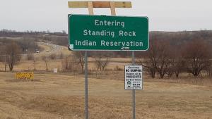 A sign marking the entrance to the Standing Rock reservation, behind which the Oceti Sakowin camp lies. 
