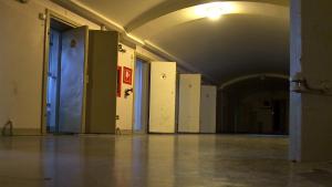 A line of solitary confinement cells with the doors open