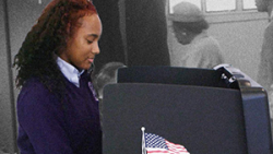 woman of color at a voting booth