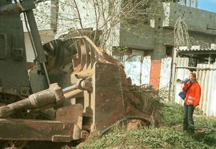 A bulldozer approaches 23-year-old peace activist Rachel Corrie