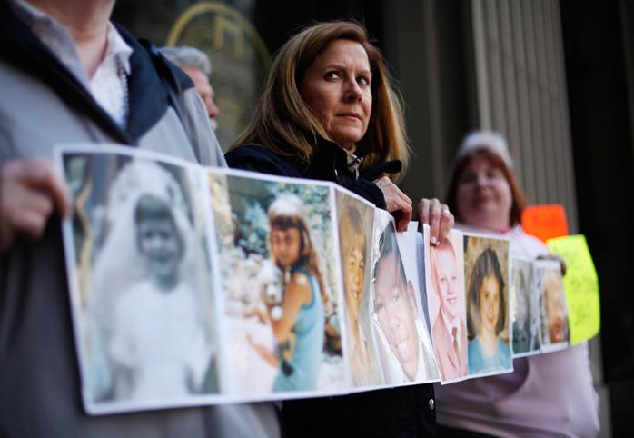 Members of the Survivors Network of those Abused by Priests hold photos of themselves at the age they were sexually assaulted by Catholic Clergy.