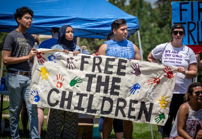 Protesters holding Feed the Children banner