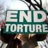 "End torture" sign