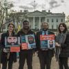 CCR Guantanamo team stands with photos of their clients in front of the White House