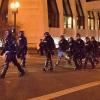 officers in riot gear marching